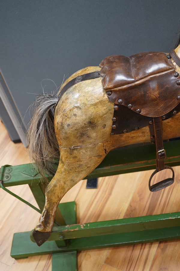 An early 20th century small dapple grey rocking horse, 92cm high, 112cm long. Condition - fair